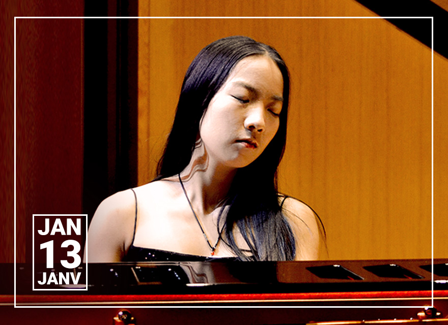 The image is a promotional photo for female pianist, Lucy Zhang, taken during a contemplative moment at a concert hall. She has long straight black hair and is wearing a dark outfit with a V-neckline and a pearl bracelet on her wrist. The pianist is leaning against a grand piano with its lid open, showing the strings and hammers inside, and her eyes are closed as if she is lost in thought or listening intently to the music. The ambient lighting casts a warm and intimate atmosphere. There is a graphic in the top left corner indicating the performance date as January 13, with the word "JANV" beneath, denoting the French abbreviation for January. The overall impression is one of elegance and introspection, connected to a classical music event in Halifax, Nova Scotia.