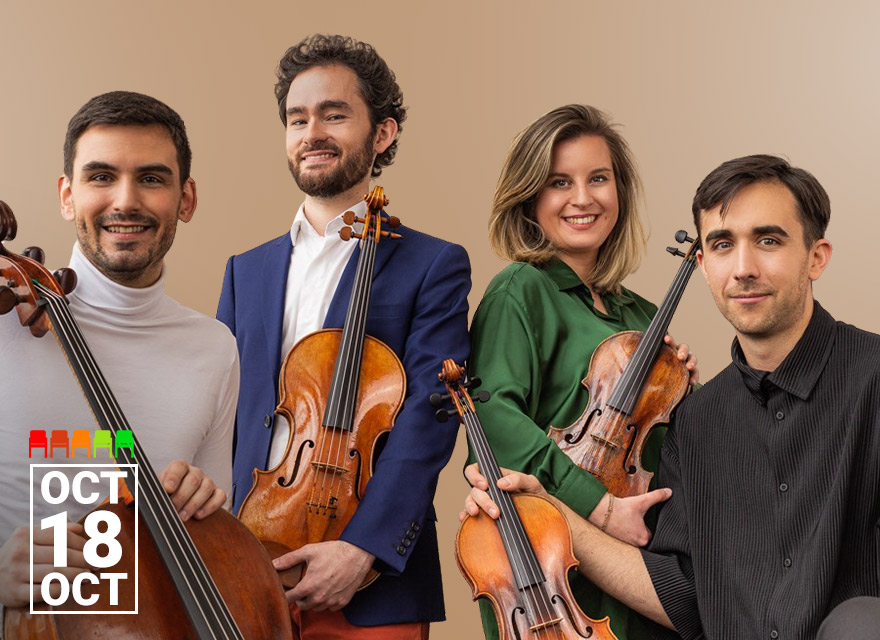 A string quartet of two violinists, a violist, and a cellist pose smiling against a beige background. The group consists of three men and one woman, each holding their instrument with relaxed confidence. They wear a mix of stylish attire—ranging from a white turtleneck and navy blazer to a green blouse and black shirt. The date "Oct 18" is displayed in the bottom left corner.