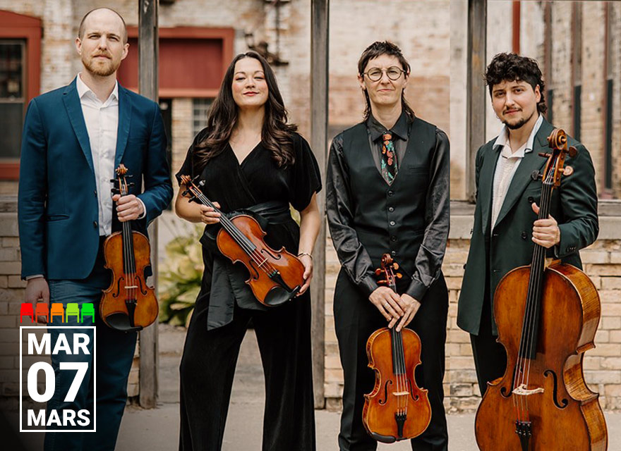 Full-length promotional image of the Thalea String Quartet standing outdoors in front of a rustic brick building. From left to right: a violinist in a blue suit holding a violin, a violist in a black outfit with long dark hair holding a viola, a violinist with short hair, glasses, and a patterned tie holding a violin, and a cellist with curly dark hair in a green suit holding a cello. All four musicians are standing confidently and smiling slightly. The date "MAR 07 / MARS" is displayed in white text on a black square in the bottom left corner.