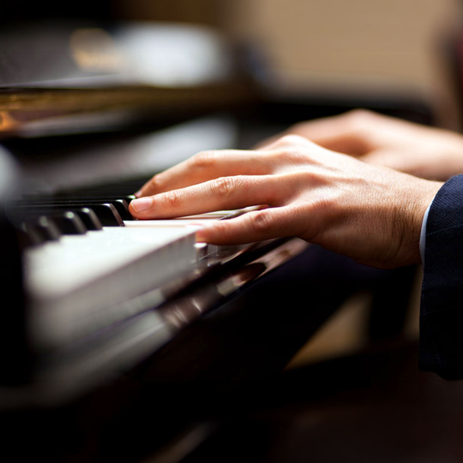 Close-up of a pianist’s hands at the keyboard, representing donations in support of Cecilia Concerts and its classical music programs.
