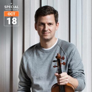 Portrait of a man in a grey sweater holding a violin against a vertical wood-panelled background. A Special Presentation graphic in the upper left displays the date October 18.